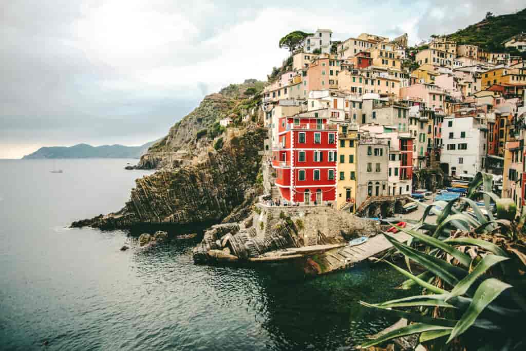 A beautiful shot of assorted-color buildings on the hill near the sea in Manarola, Italy